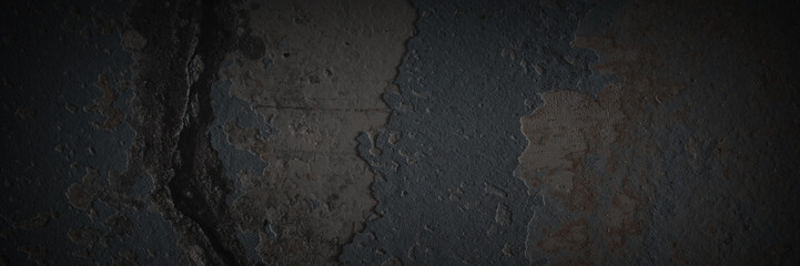 Texture of the old wall. Rough grungy surface of painted plastered concrete wall with spots, cracks, noise and grain. Dark wide panoramic background for design. Shaded vintage texture with vignette.