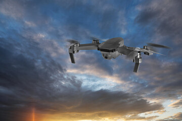 Drone with camera flying in sky. Unmanned aerial vehicle for surveillance