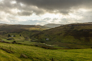 Winding roads cut through the natural wonders of the Isle of Skye: cliffs, rugged coastlines, and green hills shape a unique journey through wild beauty and unforgettable views