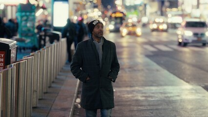 Tourist walking in Manhattan enjoying the New York City night lights