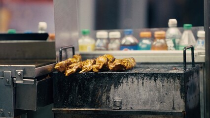 Street food vendor grilling meat skewers in Manhattan, New York City