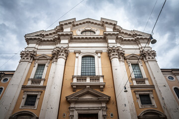 Basilica dei Santi Ambrogio e Carlo al Corso, with its ornate Baroque facade and towering columns, stands prominently on Via del Corso, reflecting Catholic heritage in Rome, italy.