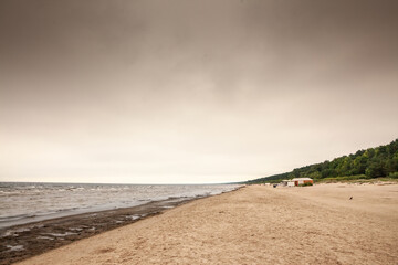 Panorama of the Jurmala beach (Jurmalas Pludmale) in Dubulti, on the baltic sea, on a rainy cloudy afternoon. Jurmala is a sea resort of Latvia in the baltic states.