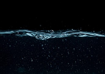 demarcation line surface liquid submerged area upper area dark showing gaseous inclusions dispersing floating close up view liquid bubbles texture curved line surface rendered film grain