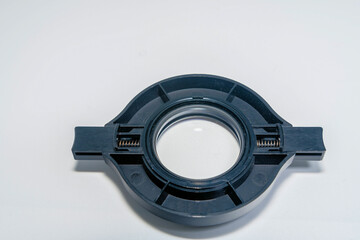 Back of microscopic lens adapter on a white background