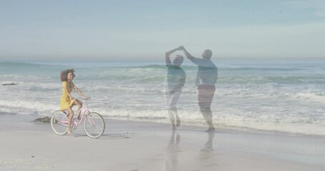 woman cycling pink bicycle on shoreline with dancing couple overlay and ocean waves for marketing - Powered by Adobe
