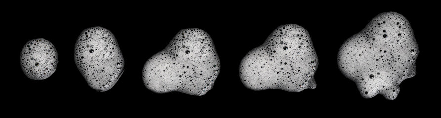 Top view set white foam soap isolated on a black background. concept of shampoo bubble, suds texture bathtub. shaving cream gel, bath lather. foam bubble