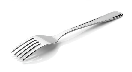 A shiny silver fork is placed diagonally on a white surface with subtle shadows underneath it here