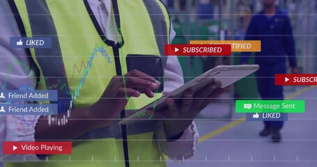 Factory manager tapping tablet and phone in plant, displaying social alerts and financial charts - Powered by Adobe