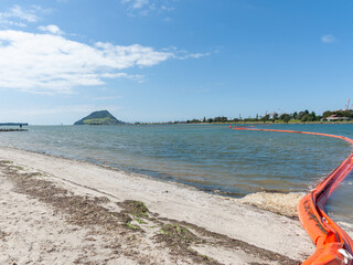 Protecting the environment from oil spills using bright red inflatable boom floating © Brian Scantlebury