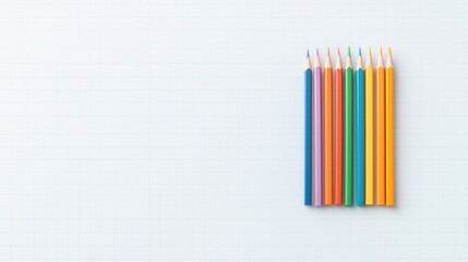 Fototapeta premium A collection of colored pencils arranged neatly against a light blue grid background, highlighting vibrant hues and a clean aesthetic.