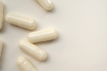 White medicine pills capsule on white background