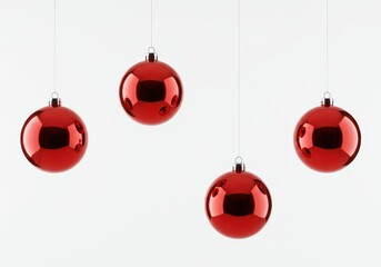 Four red christmas ornaments hanging against a plain white background in a studio setting