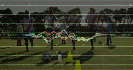 Female soccer players dribbling through yellow cones on field, showing analytics overlay grid - Powered by Adobe