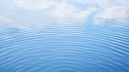 Naklejka premium A serene water surface reflecting clouds, showcasing gentle ripples that create a calming visual effect.