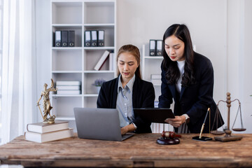 Asian Business woman and lawyer discuss the contract document. Treaty of the law. Sign a contract business lawyer Business partnership meeting concept.
