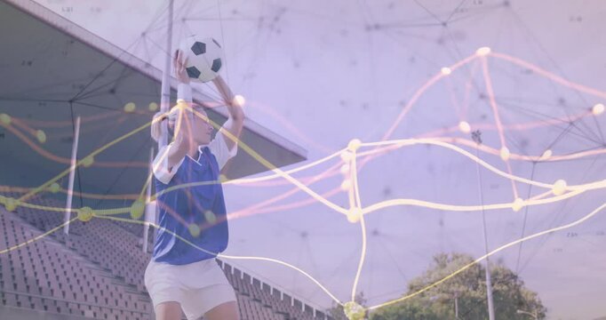 Female soccer player throwing ball on stadium sideline showing digital data overlay for analytics