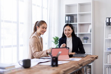 Asian company employees and colleagues work together in the office. Doing accounting analysis report real estate investment data, Financial and tax systems concept.
