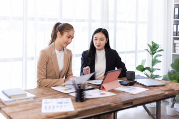 Asian company employees and colleagues work together in the office. Doing accounting analysis report real estate investment data, Financial and tax systems concept.
