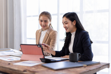 Asian company employees and colleagues work together in the office. Doing accounting analysis report real estate investment data, Financial and tax systems concept.
