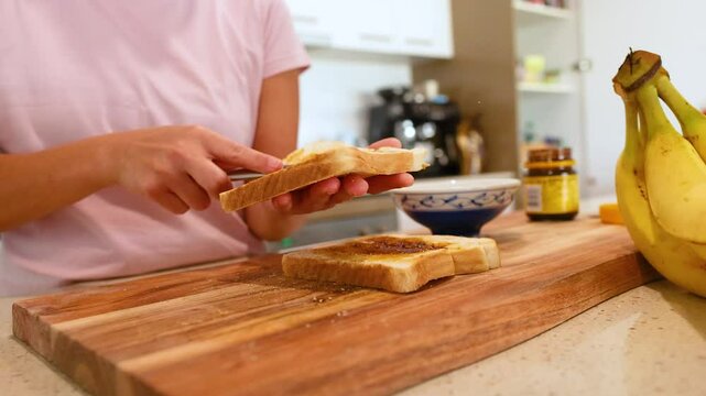 Spreading Vegemite on Toast in a Kitchen Setting