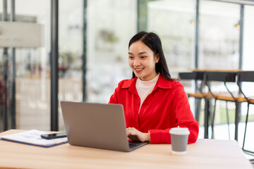 Business Employee Asian woman working on laptop document archives on folders papers at busy work at...
