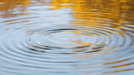 A serene image of ripples in water, reflecting warm autumn colors, evoking tranquility and a sense of nature's beauty.