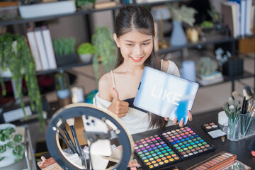 Beauty influencer Asian girl Using Social Media for live streaming on Smartphone online audience like and subscribe to her channel. Like, Follower, Comment
