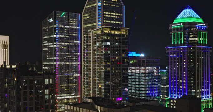 Charlotte North Carolina Aerial v110 low tracking flyover Third and Fourth Wards capturing vibrant downtown night cityscape with towering skyscrapers - Shot with Inspire 3 8k - Oct 1st 2023