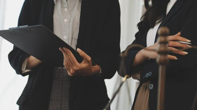 Judge gavel with Justice lawyers having team meeting at law firm background. Concepts of Law and Legal services.