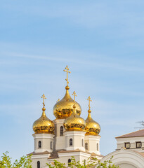 The golden domes of the Christian church in sunset light.