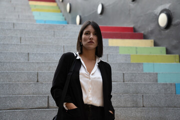 Confident businesswoman posing on vibrant urban steps