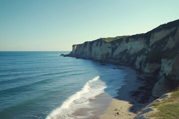 Obraz premium Picturesque Coastal Scenery With Cliffs Ocean And Sandy Beach Under Bright Sky