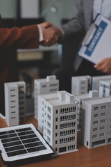 Discussion among businesspeople on the latest developments in solar cell panel technology and Solar Energy Environment city Concept.