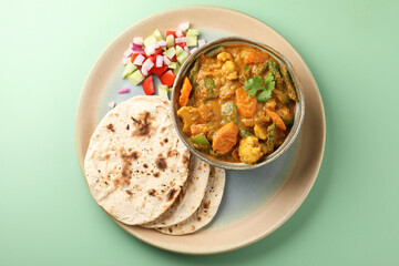 Indian traditional cuisine food mix veg curry made with carrots potatoes cauliflower beans and bell peppers with tandoori roti