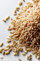 Obraz premium Brown Rice Scattered on a White Background