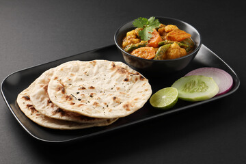 Indian traditional cuisine food mix veg curry made with carrots potatoes cauliflower beans and bell peppers with tandoori roti