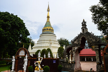 Fototapeta premium Pagoda and Chapel, Lanna Architecture, Symbols of Buddhism, South East Asia at Wat Buppharam, Chiang Mai, Northern Thailand