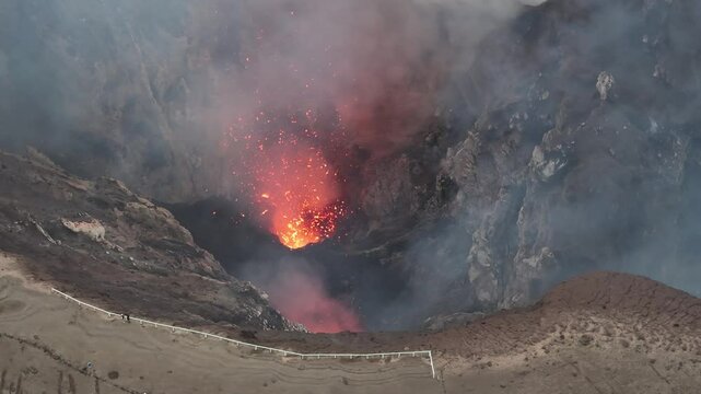 Small eruption of Mount Yasur Active Volcano in Vanuatu. Aerial over crater rim, nature wonder.