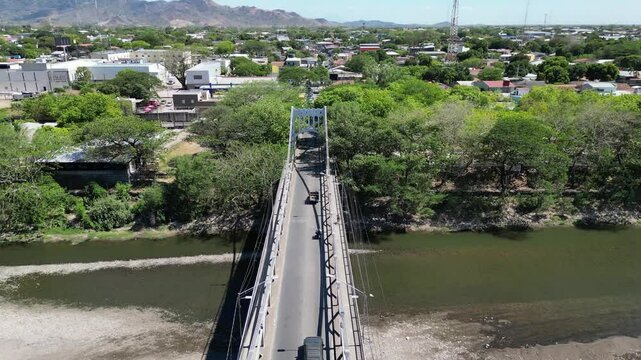 Aerial view of Choluteca, Honduras with iconic suspension bridge and urban landscape