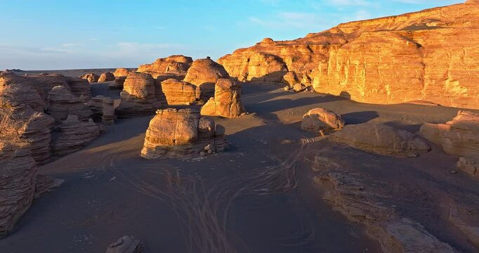 Aerial shot of the yardang landform mountain in desert at sunrise. Famous Dahaidao no man's land natural scenery in Xinjiang, China.