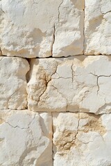 Naklejka premium Ancient Weathered Stone Wall Texture: Cracked Limestone Blocks, Beige and Off-White Hues, Detailed Close-Up Photography
