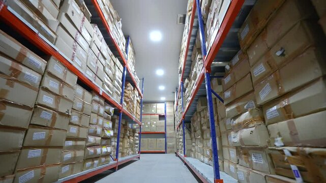 carton boxes in warehouse area cleanroom with colored racks for storage and epoxy flooring in a pharmaceutical manufacturing factory for active pharma ingredients, speciality chemicals, cardboard box
