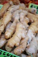Fresh ginger roots displayed at a local market stall in morning light