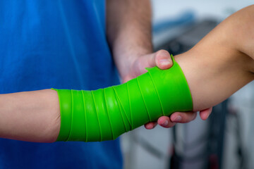 Woman undergoing smart flossing therapy on her knee during a physical therapy session. Tissue...