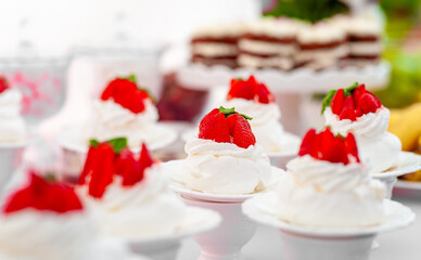 Delicious Meringue Desserts Topped With Strawberries and Whipped Cream on Display