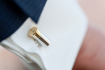 Elegant Gold and Silver Cufflink on a Formal White Shirt Sleeve