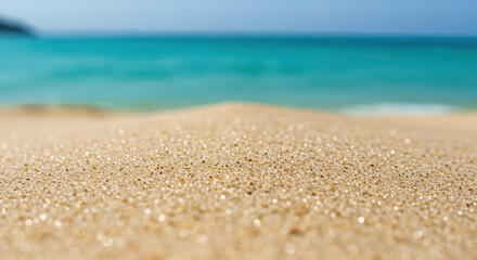 Close-up of sparkling sand grains with turquoise ocean water in soft focus background. Beach macro. Tropical vacation texture. Summer holiday concept. Natural seashore detail. Marine environment.