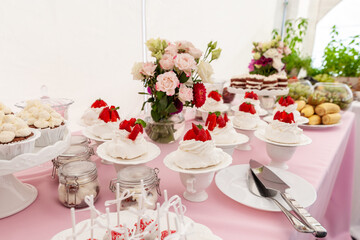 Beautiful Wedding Dessert Table Display with Floral Decorations and Sweet Treats