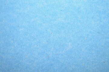 A delicate close-up of a textured blue surface of paper folder, revealing a serene interplay of smooth gradients and intricate patterns for a calming visual effect